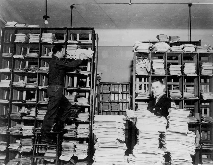 U.S. Army personnel are sorting through stacks of German documents that were collected by war crimes investigators as evidence for the trial before the International Military Tribunal for the Prosecution of War Criminals in Nuremberg
